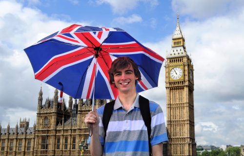 Big Ben, Parliarment building and tourist with British flag umbrella in London